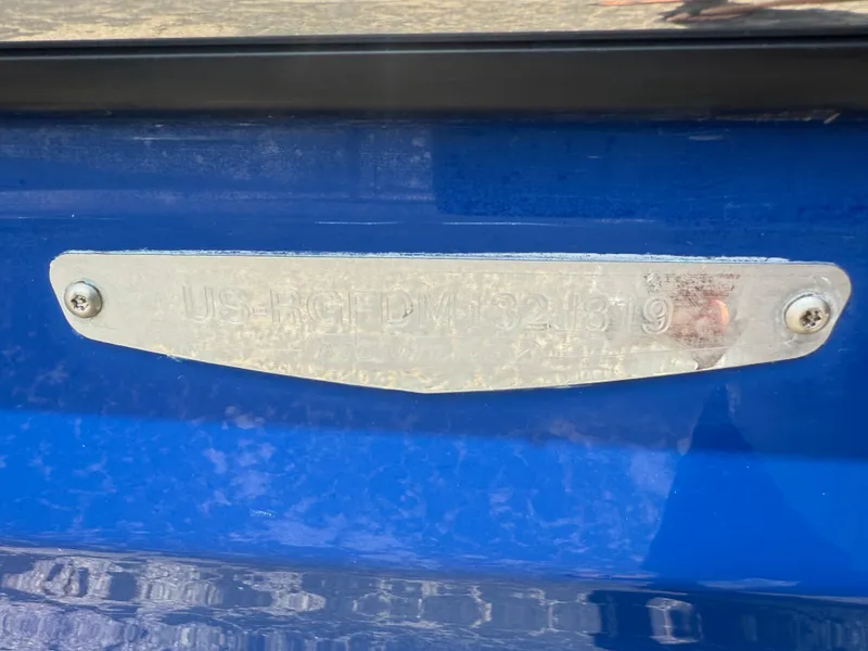 Slide: The Image of 2019 Monterey MX6 SURF boat identification plate on blue surface. - 36