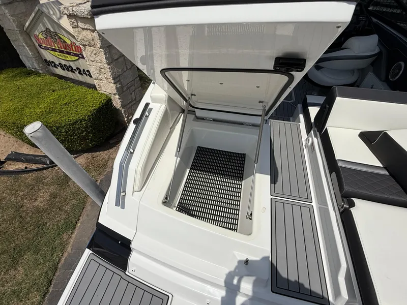 Slide: The Image of 2019 Monterey MX6 SURF boat with open storage compartment, showcasing sleek design and functionality. - 42