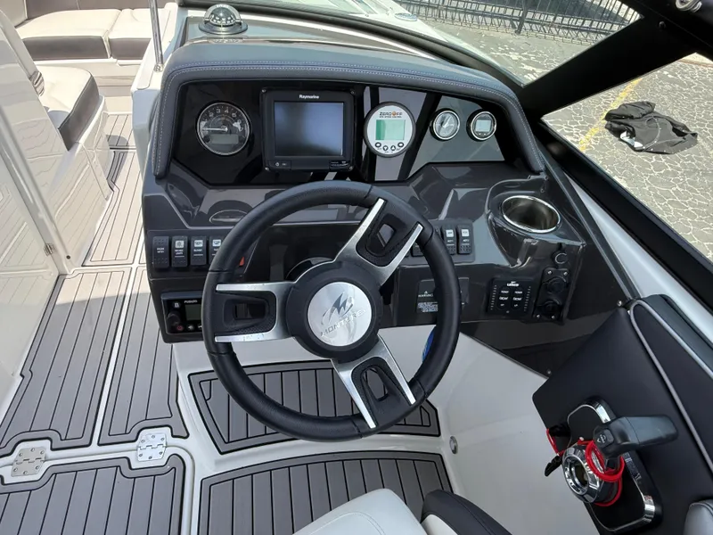 Slide: The Image of 2019 Monterey MX6 SURF boat dashboard with steering wheel and control panel. - 48