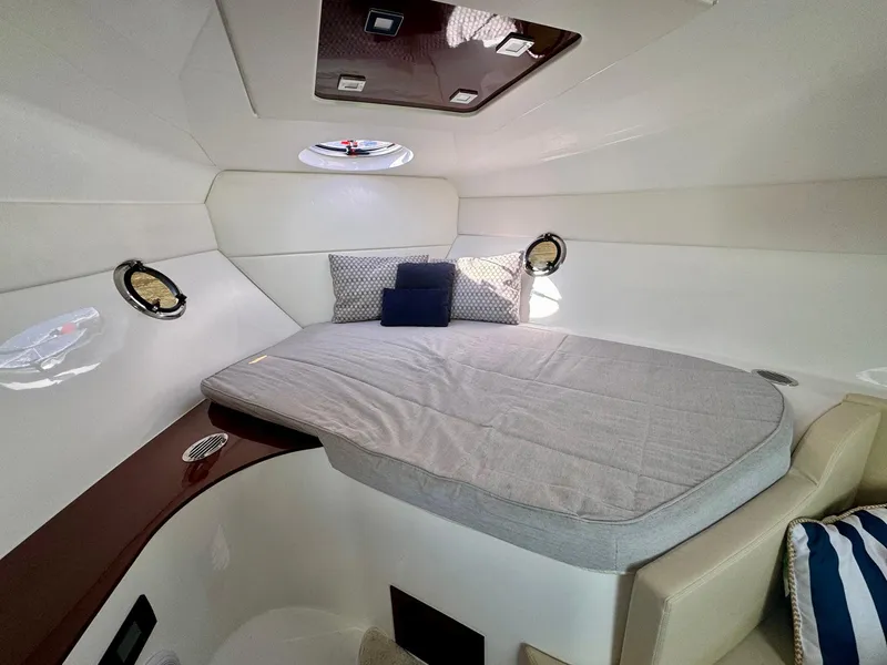 Slide: The Image of 2023 Schaefer 375 yacht cabin with cozy bed, portholes, and modern interior design. - 10