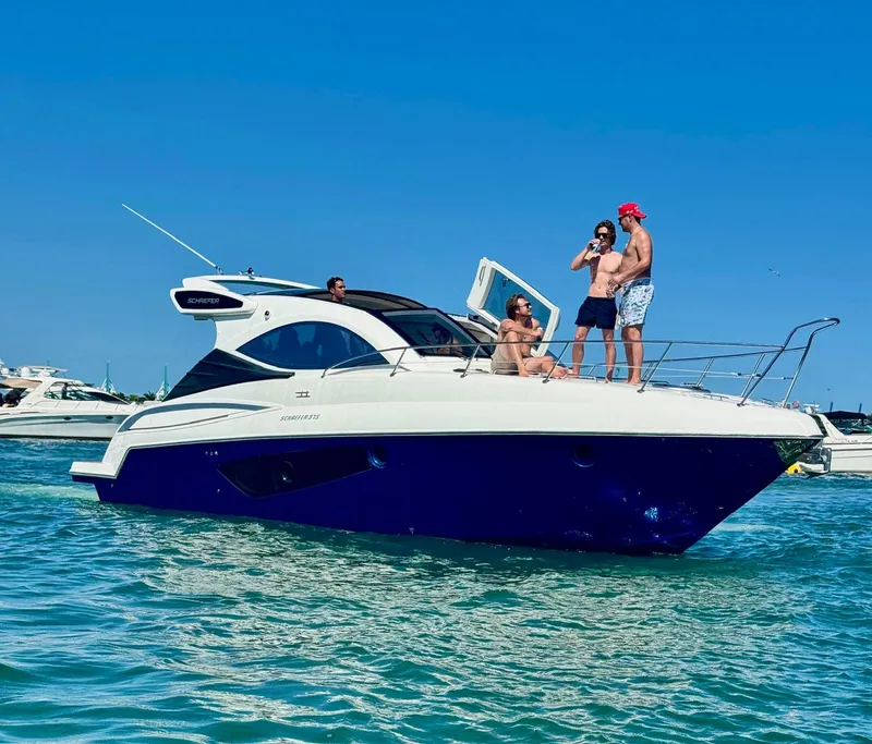 Slide: The Image of 2023 Schaefer 375 yacht with people enjoying a sunny day on the water. - 16