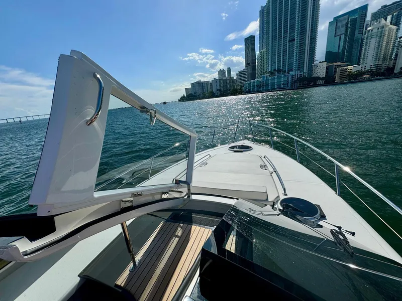 Slide: The Image of Schaefer 375 yacht cruising near city skyline, 2023 model, sunny day on the water. - 19