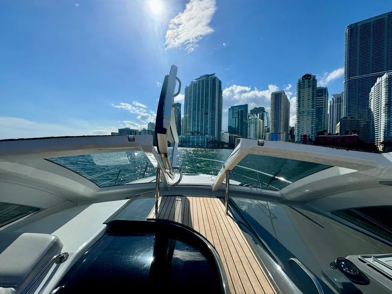 Slide: The Image of Schaefer 375 yacht cruising near city skyline under clear blue sky, 2023 model. - 21