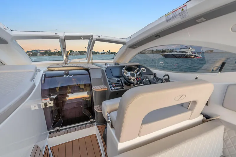 Slide: The Image of 2023 Schaefer 375 yacht interior with modern helm and luxurious seating. - 24