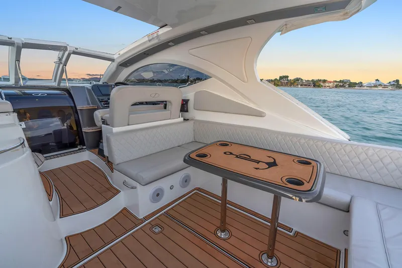 Slide: The Image of Luxurious 2023 Schaefer 375 yacht interior with elegant seating and wooden table, overlooking serene waters. - 26