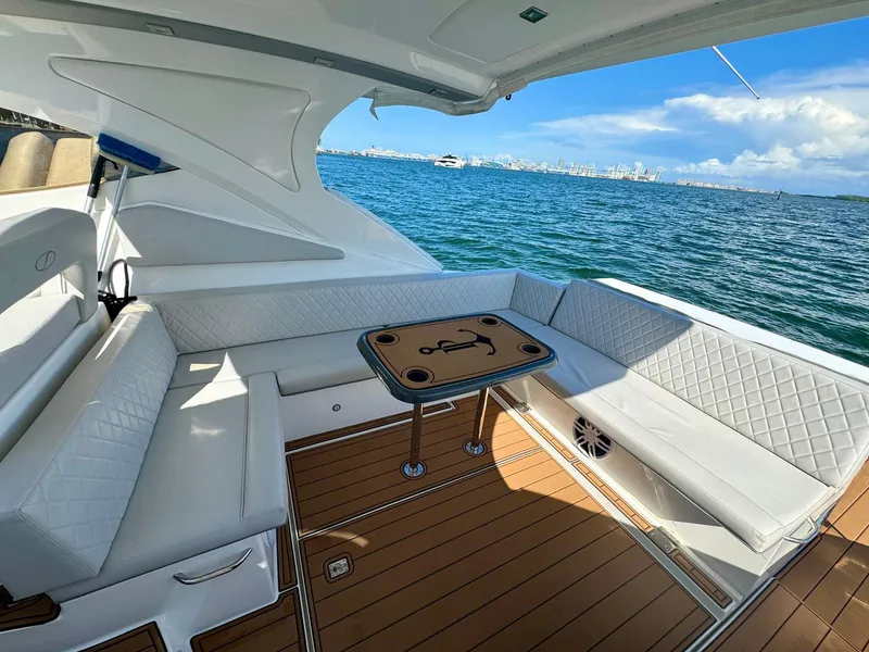 Slide: The Image of Luxurious 2023 Schaefer 375 yacht interior with white seating and ocean view. - 27