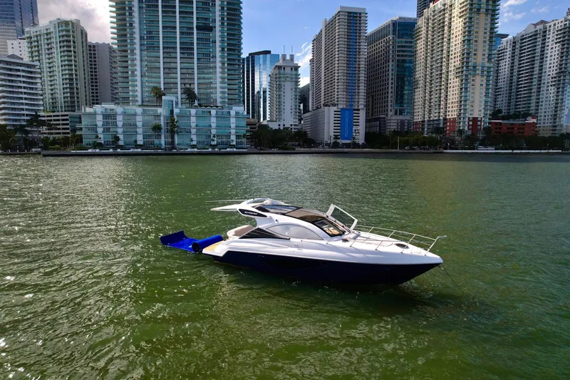 Slide: The Image of 2023 Schaefer 375 yacht on water with city skyline backdrop. - 32