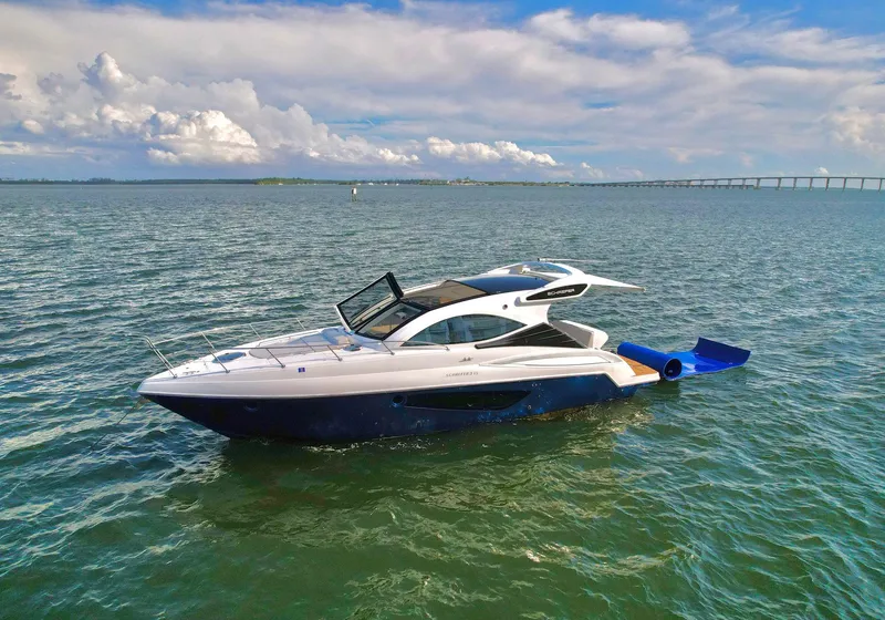 Slide: The Image of 2023 Schaefer 375 yacht cruising on open water under a partly cloudy sky. - 34