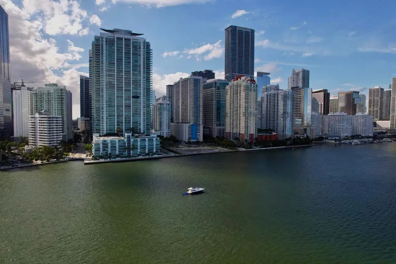 Slide: The Image of Aerial view of a Schaefer 375 yacht on water with city skyline, 2023. - 35