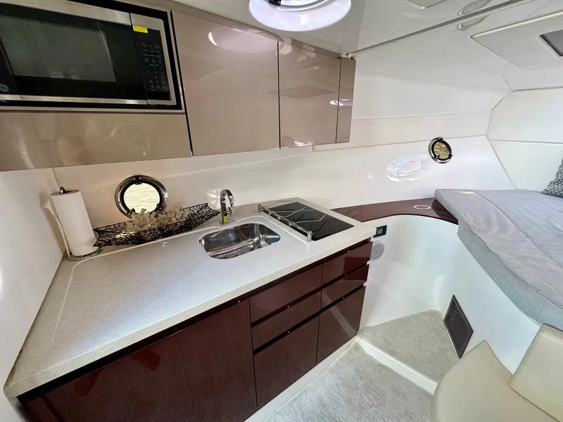 Slide: The Image of Modern Schaefer 375 yacht interior with kitchenette, sink, and bed, 2023 model. - 9