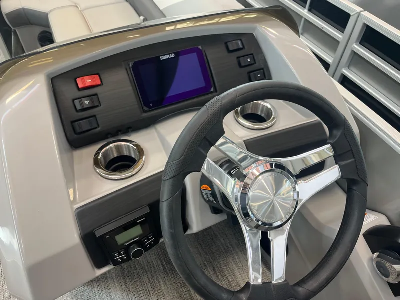Slide: The Image of 2025 Bennington 22SXSRC boat dashboard with steering wheel and control panel. - 13
