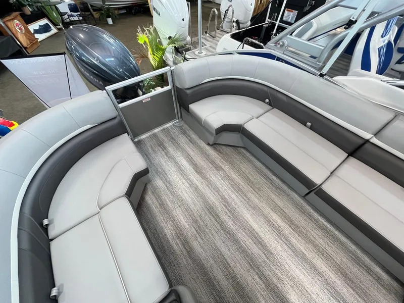 Slide: The Image of 2025 Bennington 22SXSRC pontoon boat interior with gray seating and striped flooring. - 4