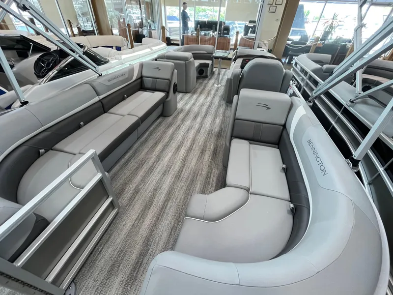 Slide: The Image of 2025 Bennington 22SXSRC pontoon boat interior with luxurious gray seating and spacious layout. - 6