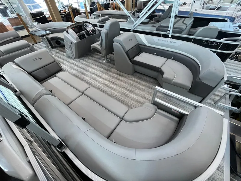 Slide: The Image of 2025 Bennington 22SXSRC pontoon boat interior with luxurious gray seating and modern design. - 7