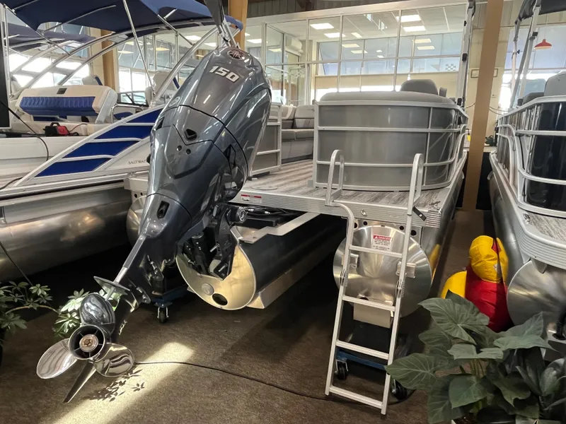 Slide: The Image of 2025 Bennington 22SXSRC pontoon boat with powerful 150 HP outboard motor in showroom. - 8