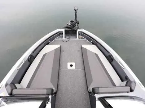 Slide: The Image of 2026 Lund 202 PRO V GL boat interior with gray seating and carpeted deck. - 11