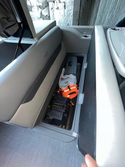 Slide: The Image of 2023 Princecraft Vectra 23 LT boat storage compartment with safety gear and equipment. - 10
