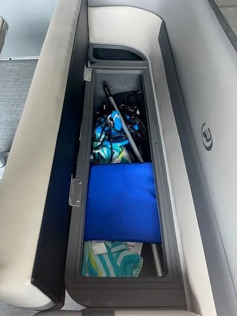 Slide: The Image of Storage compartment in 2023 Princecraft Vectra 23 LT boat, containing various boating accessories. - 14