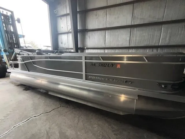 Slide: The Image of 2023 Princecraft Vectra 23 LT pontoon boat in storage facility. - 2
