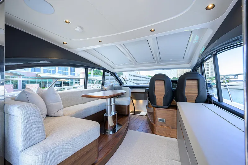 Slide: The Image of Luxurious interior of 2026 Princess V50 Deck Salon yacht with modern seating and panoramic windows. - 16