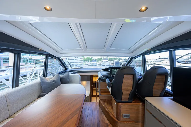 Slide: The Image of Luxurious interior of 2026 Princess V50 Deck Salon yacht with modern seating and helm. - 18