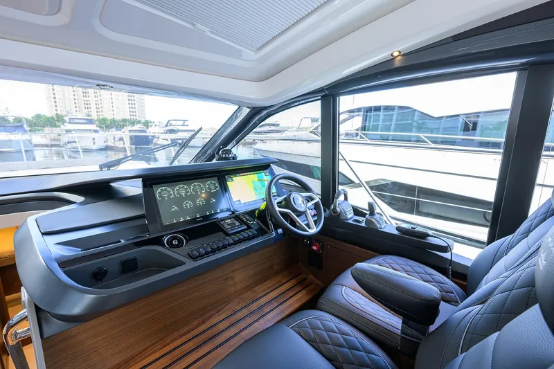 Slide: The Image of Modern helm of 2026 Princess V50 Deck Salon yacht with advanced navigation displays. - 19