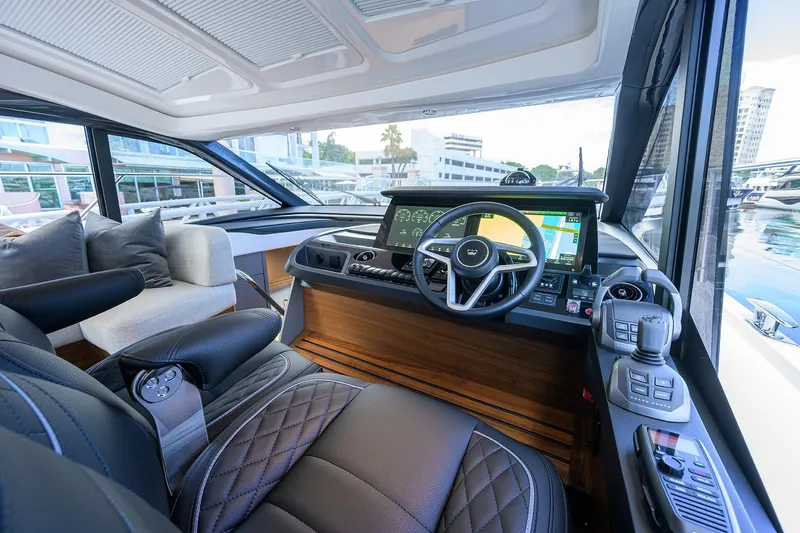 Slide: The Image of Luxurious 2026 Princess V50 Deck Salon yacht interior with modern steering and navigation systems. - 21