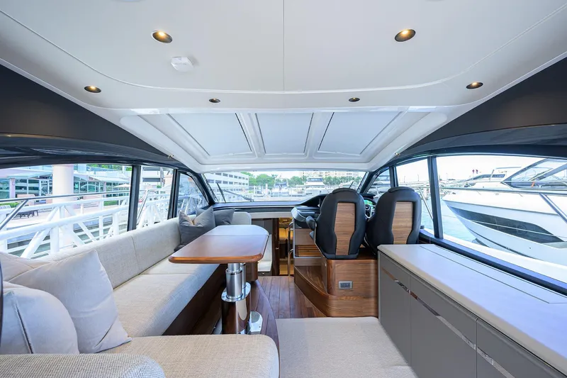 Slide: The Image of Luxurious interior of 2026 Princess V50 Deck Salon yacht with modern seating and panoramic windows. - 23