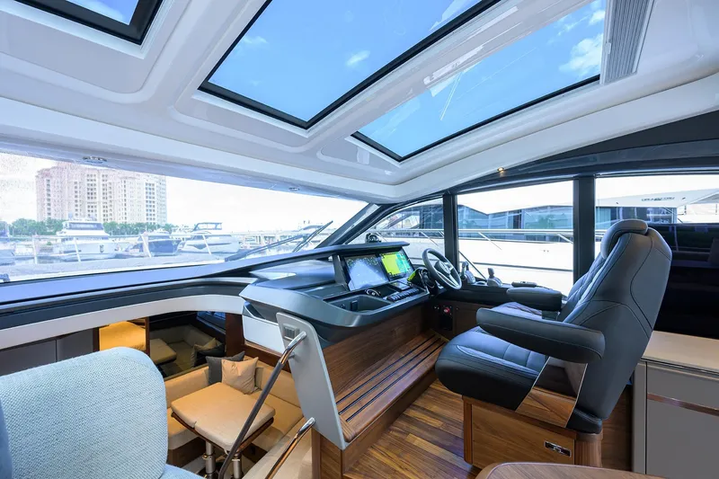Slide: The Image of Luxurious 2026 Princess V50 Deck Salon interior with modern helm and panoramic windows. - 25