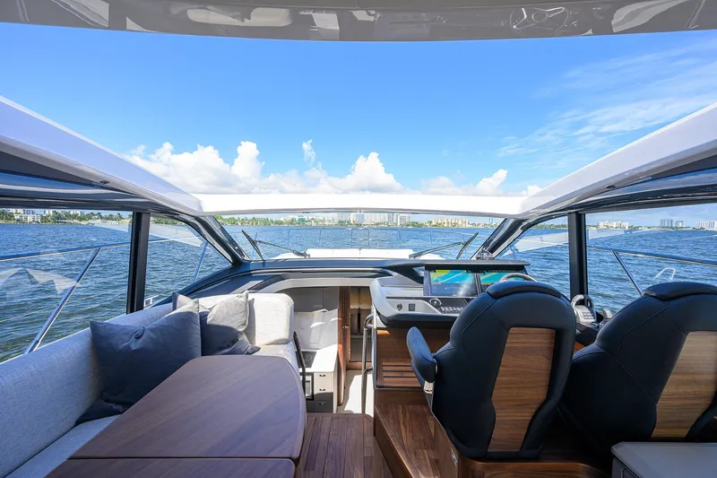 Slide: The Image of Interior view of 2026 Princess V50 Deck Salon yacht with luxurious seating and navigation system. - 28