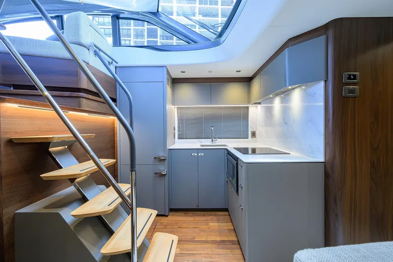 Slide: The Image of Modern kitchen interior of 2026 Princess V50 Deck Salon yacht, featuring sleek design and wooden accents. - 29