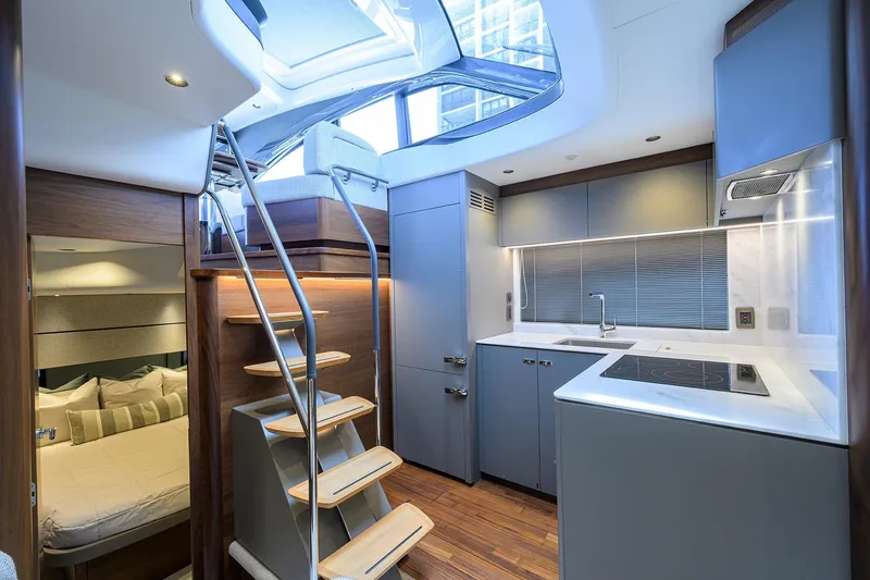 Slide: The Image of Modern interior of 2026 Princess V50 Deck Salon yacht with sleek kitchen and cozy bedroom. - 30
