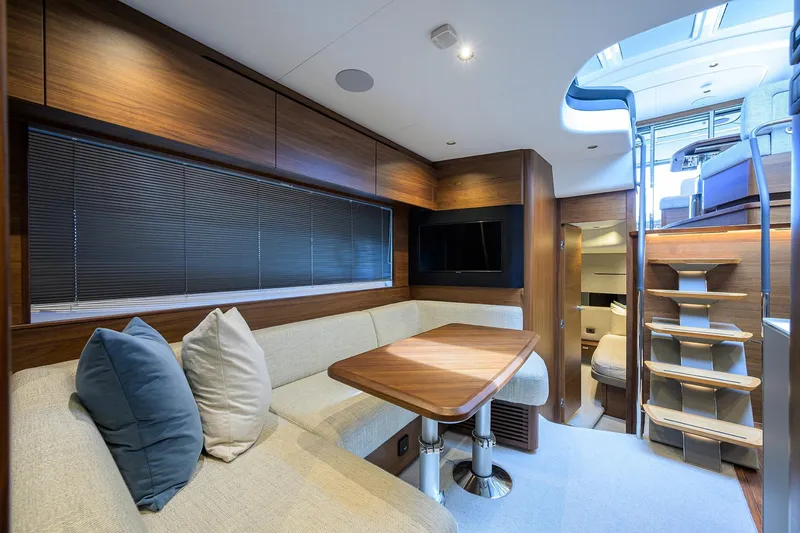 Slide: The Image of Luxurious interior of 2026 Princess V50 Deck Salon yacht with modern seating and wooden finishes. - 32