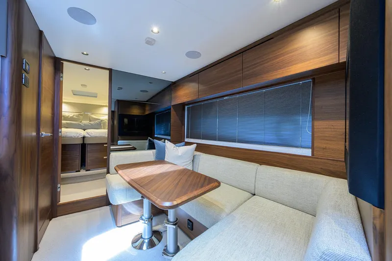 Slide: The Image of Luxurious interior of 2026 Princess V50 Deck Salon yacht with elegant wood finishes. - 33