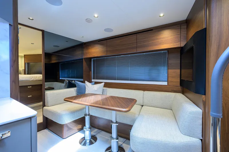 Slide: The Image of Luxurious interior of 2026 Princess V50 Deck Salon yacht with elegant wood finishes. - 34