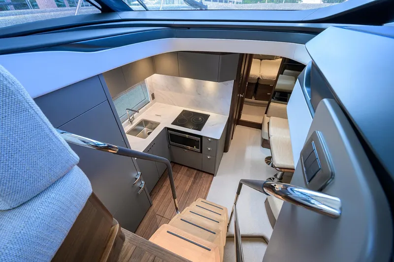 Slide: The Image of Modern kitchen interior of 2026 Princess V50 Deck Salon yacht, featuring sleek design and amenities. - 4