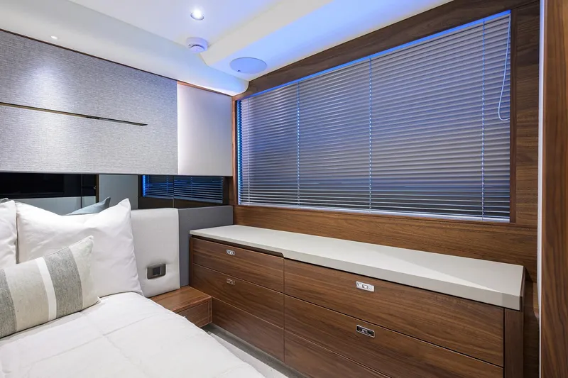 Slide: The Image of Luxurious interior of 2026 Princess V50 Deck Salon with modern wood finishes and elegant bedding. - 40