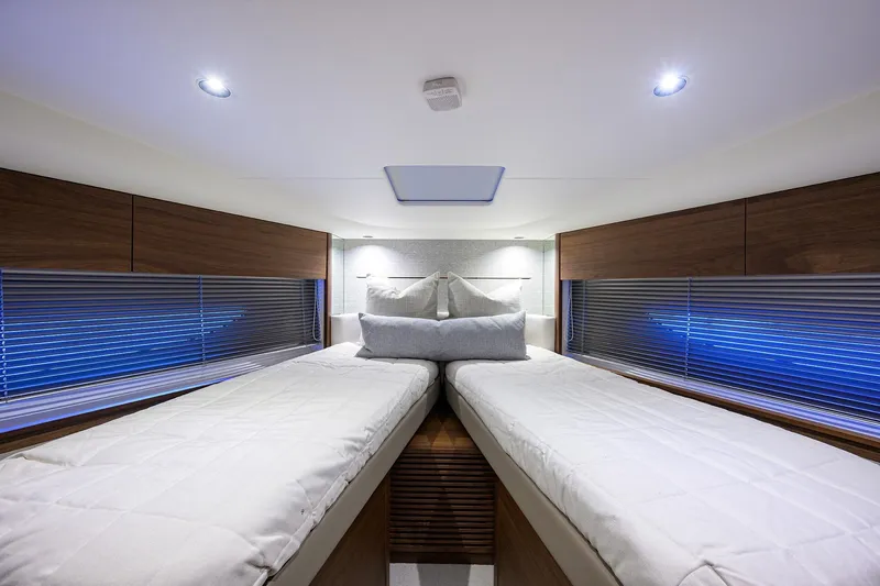 Slide: The Image of Luxurious interior of 2026 Princess V50 Deck Salon yacht cabin with twin beds. - 46