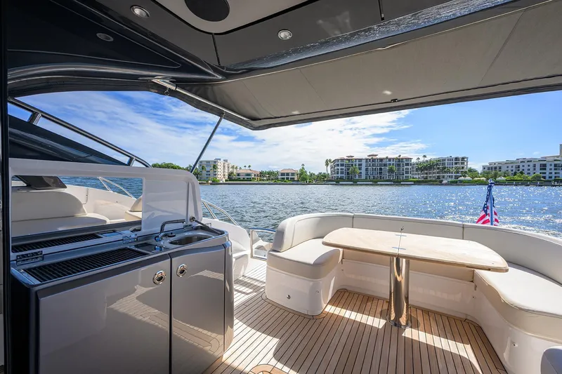 Slide: The Image of Luxurious 2026 Princess V50 Deck Salon yacht with elegant outdoor seating and waterfront view. - 6