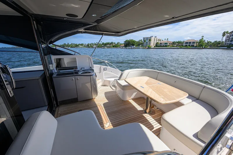 Slide: The Image of Luxurious 2026 Princess V50 Deck Salon yacht interior with elegant seating and scenic water view. - 9