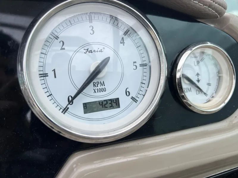 Slide: The Image of 2018 Regal Commodore 258 boat interior with white and beige seating, cup holders, and sleek design. - 13