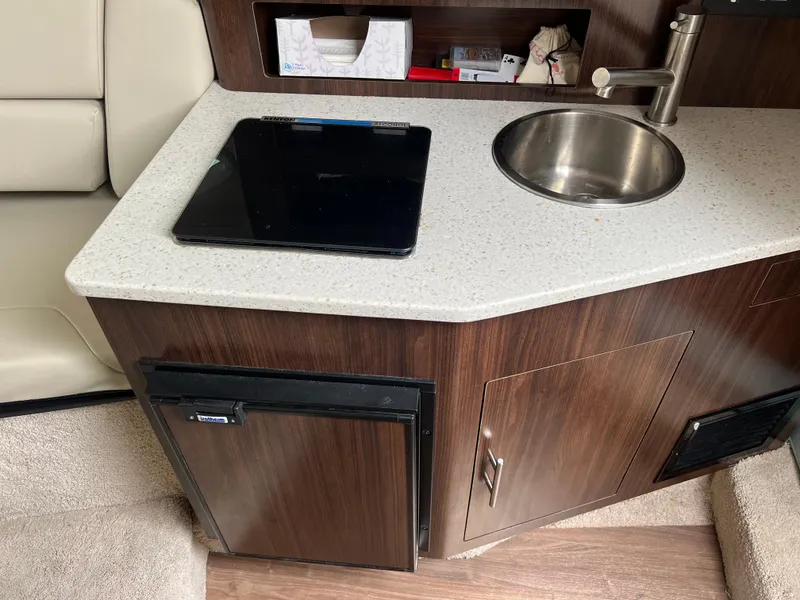 Slide: The Image of 2018 Regal Commodore 258 interior with beige leather seating and striped cushion. - 17