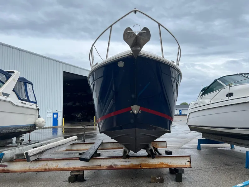 Slide: The Image of 2018 Regal Commodore 258 boat dashboard with steering wheel and control panel. - 2