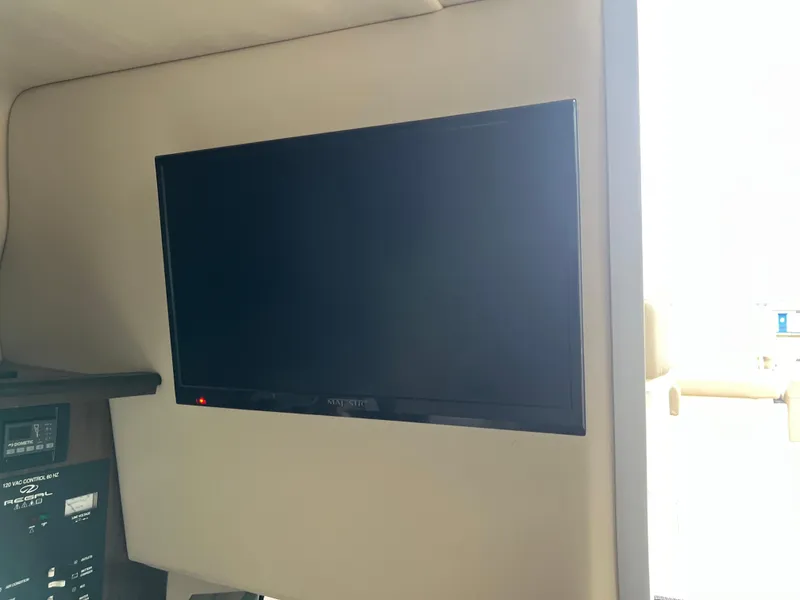 Slide: The Image of Cozy cabin interior of 2018 Regal Commodore 258 boat with bed and wooden steps. - 20