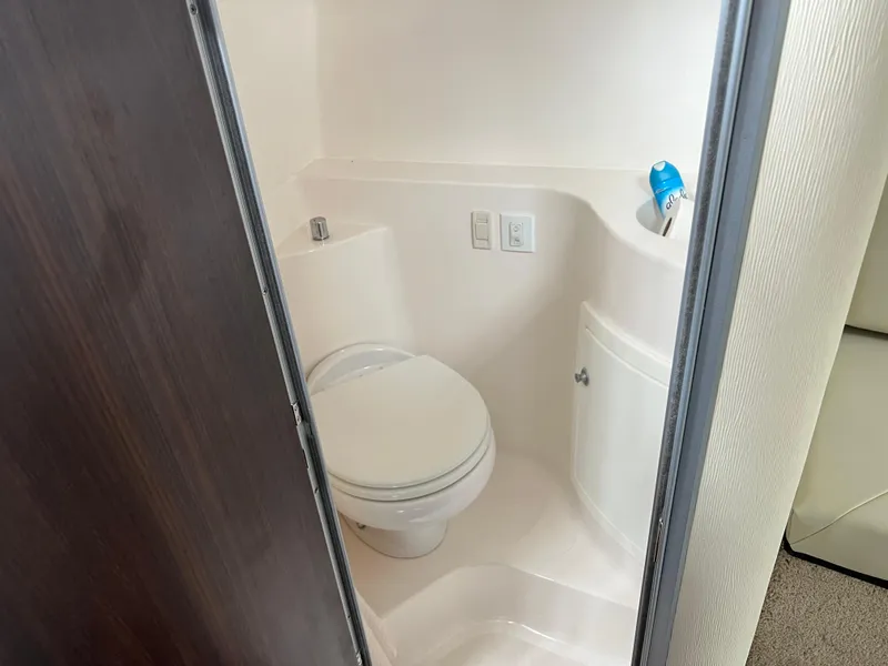 Slide: The Image of Flat-screen TV inside 2018 Regal Commodore 258 boat cabin. - 21