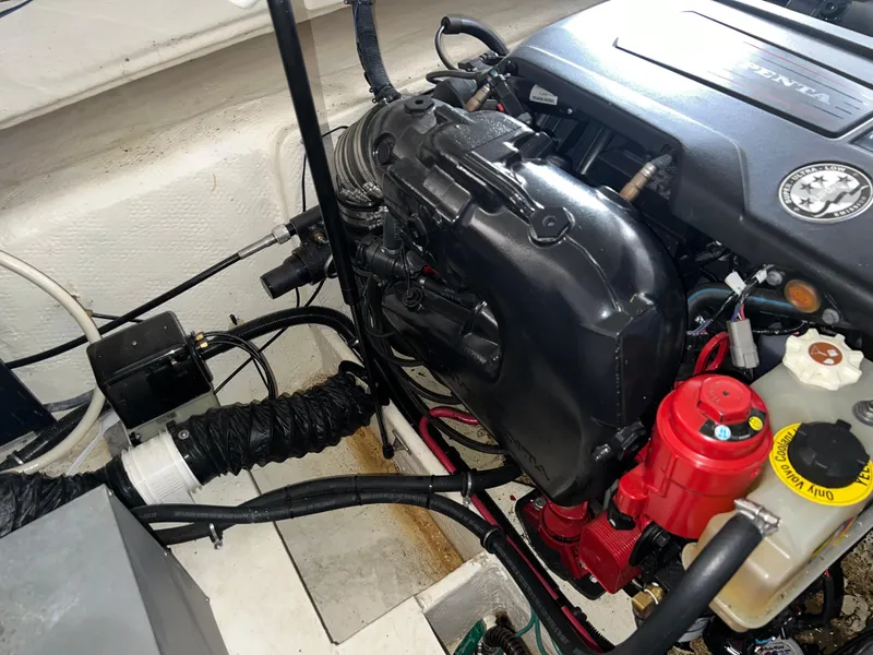 Slide: The Image of Engine compartment of a 2018 Regal Commodore 258 boat, showcasing detailed components. - 24