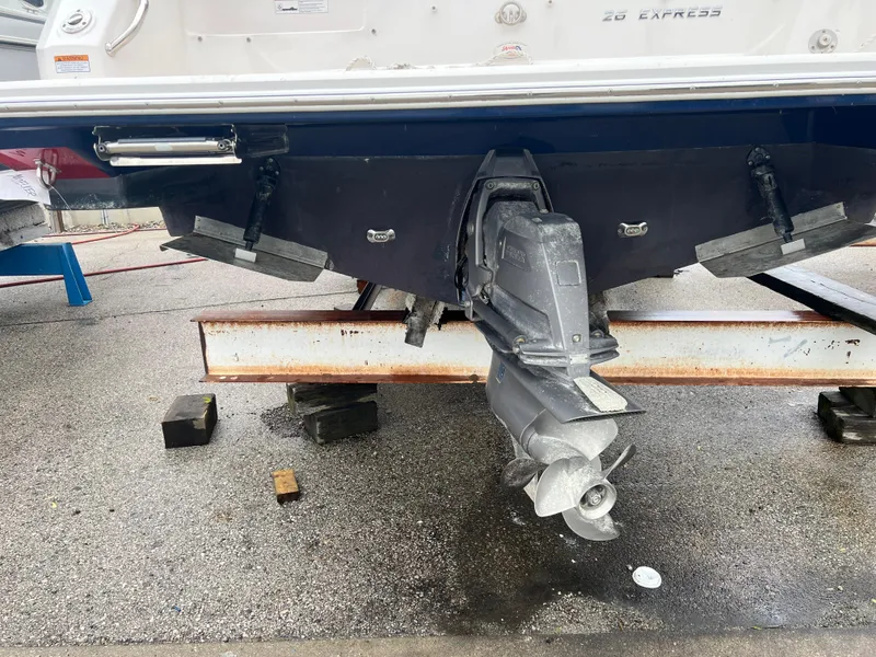 Slide: The Image of 2018 Regal Commodore 258 boat on trailer, overcast sky, marina background. - 5