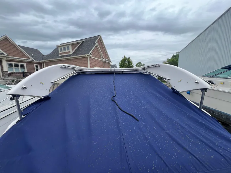 Slide: The Image of 2018 Regal Commodore 258 boat on trailer at marina, overcast sky. - 6