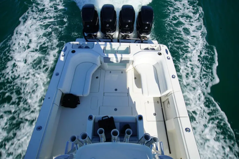 Slide: The Image of 2018 SeaVee 390Z boat with quad engines, spacious deck, and rod holders on open water. - 12