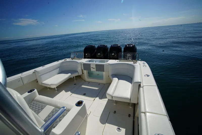 Slide: The Image of 2018 SeaVee 390Z boat with spacious deck and multiple engines on open water. - 13